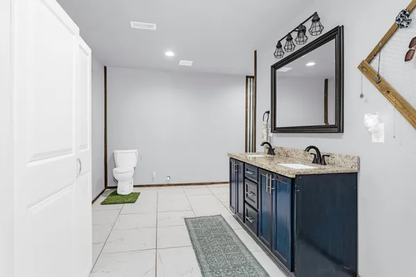 a bathroom with a tub sink and mirror