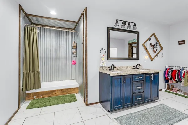 a kitchen with stainless steel appliances granite countertop a sink and a refrigerator