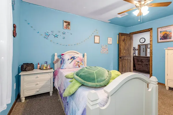 a bedroom with a bed and a chandelier