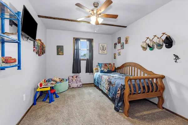 a bedroom with a bed and a chandelier
