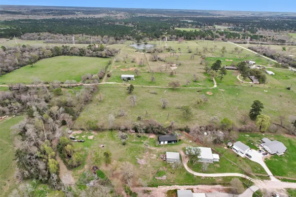 an aerial view of a house with a yard