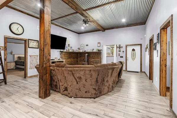 a view of a kitchen with furniture and wooden floor