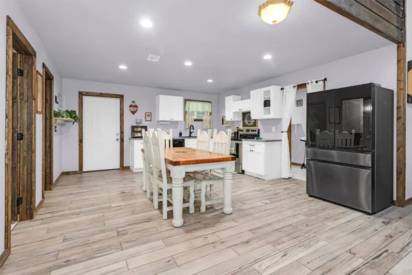 a kitchen with stainless steel appliances a refrigerator and a stove top oven
