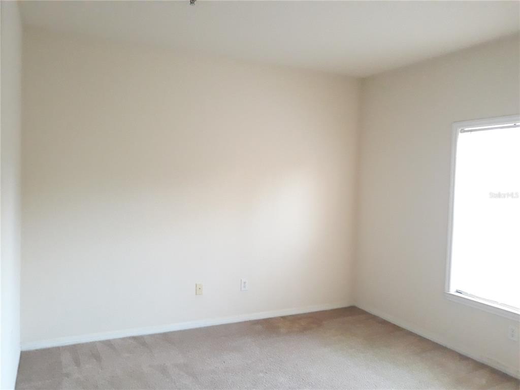3589 Conroy Road, Unit 1021 Orlando, FL 32839 - Photo 11 of 13 an empty room with a window