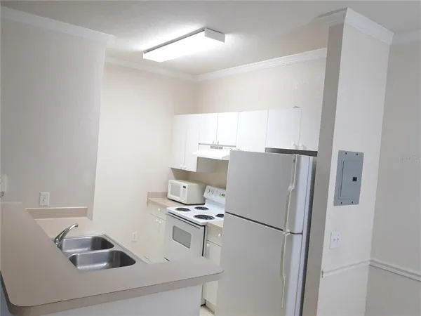 a white refrigerator freezer sitting inside of a kitchen