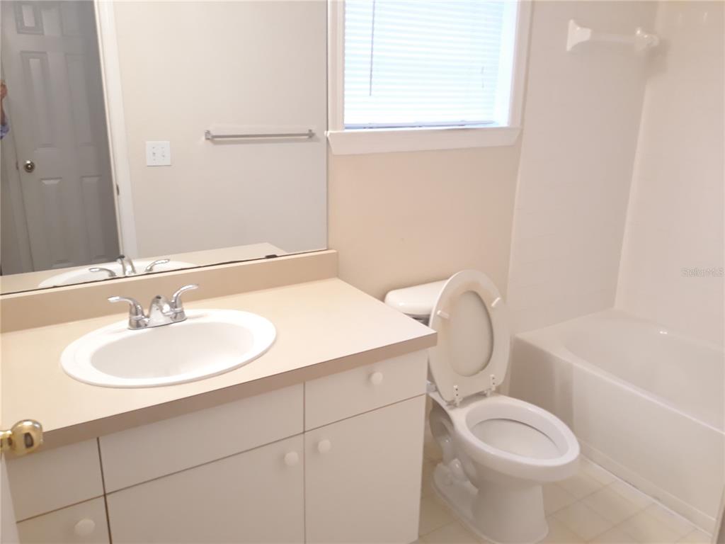 3589 Conroy Road, Unit 1021 Orlando, FL 32839 - Photo 7 of 13 a bathroom with a sink toilet and shower