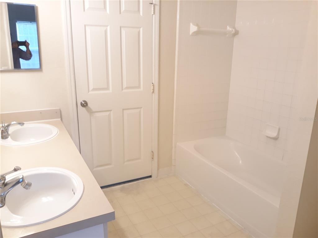 3589 Conroy Road, Unit 1021 Orlando, FL 32839 - Photo 9 of 13 a bathroom with a sink a toilet and shower