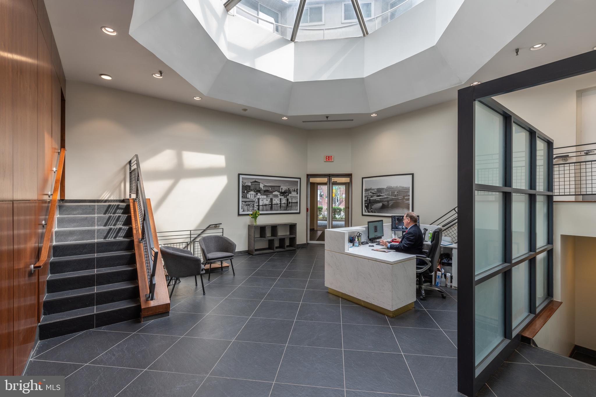 2301 Cherry Street, Unit 5F Philadelphia, PA 19103 - Photo 19 of 26 a living room with furniture and a chandelier