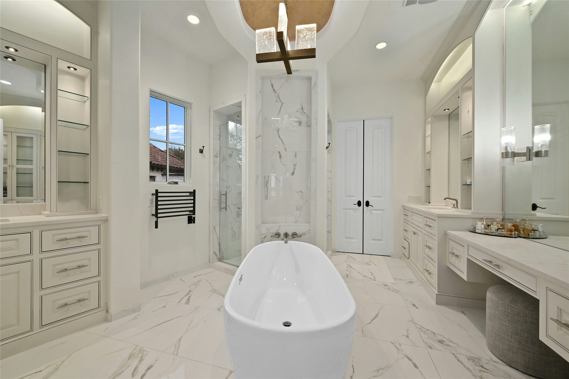 16012 Canard Circle Austin, TX 78734 - Photo 14 of 37 a spacious bathroom with a granite countertop sink a toilet a mirror and shower