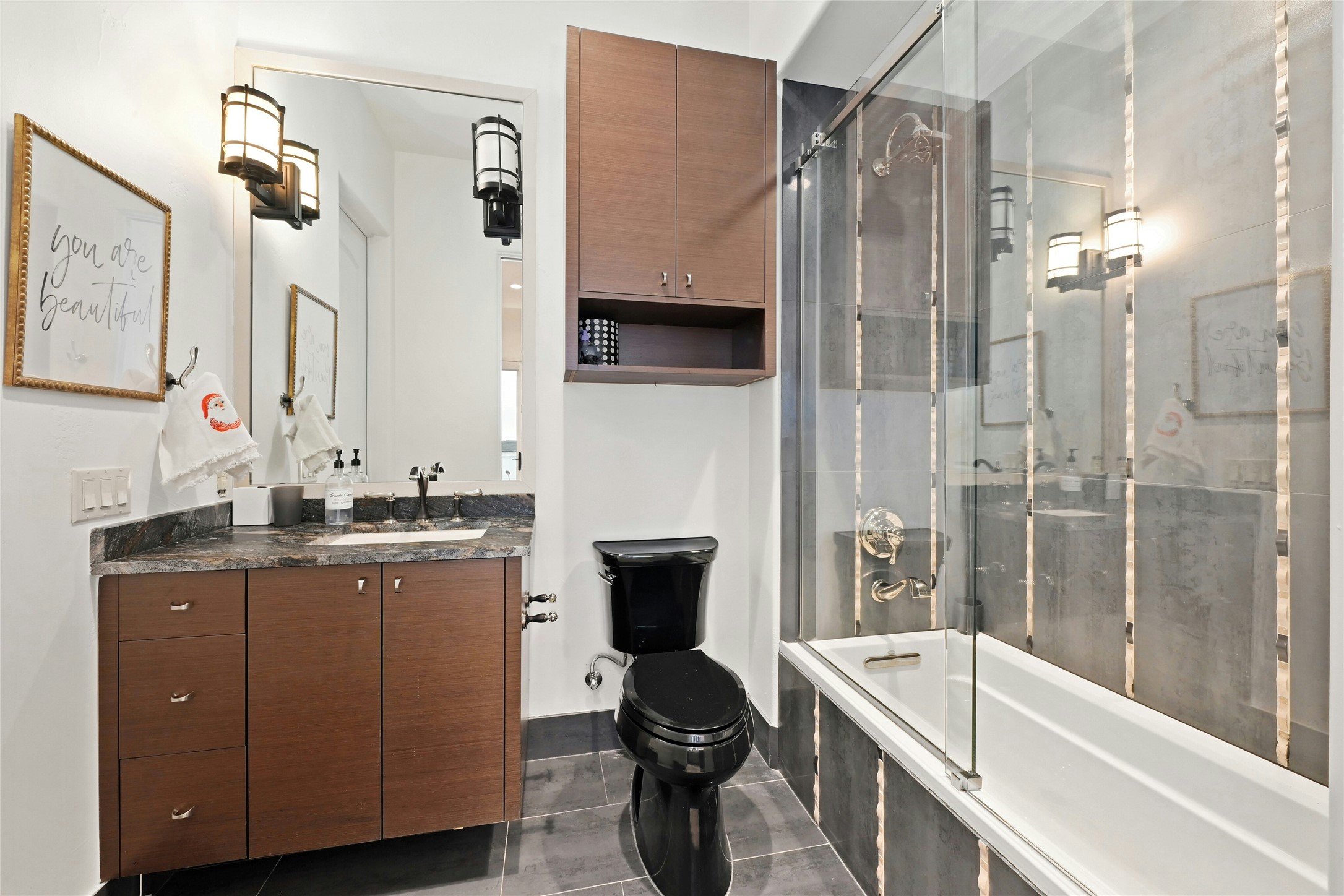 16012 Canard Circle Austin, TX 78734 - Photo 19 of 37 a bathroom with a granite countertop sink a toilet a mirror and shower