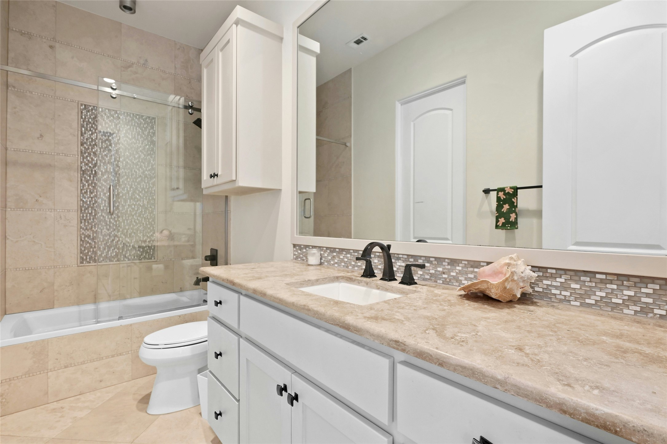 16012 Canard Circle Austin, TX 78734 - Photo 23 of 37 a bathroom with a granite countertop toilet a sink and a bathtub