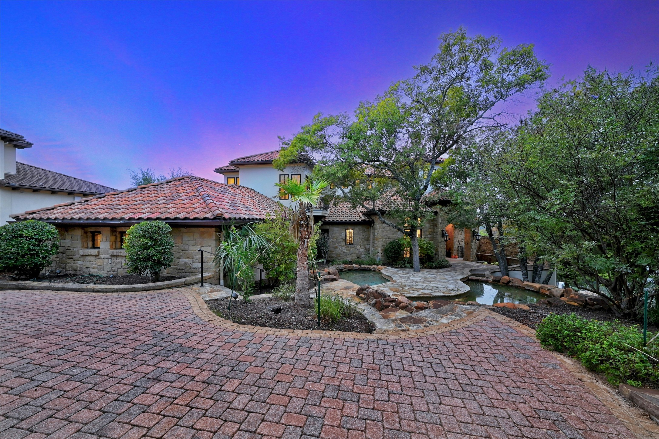 16012 Canard Circle Austin, TX 78734 - Photo 32 of 37 a view of a patio with table and chairs under an umbrella