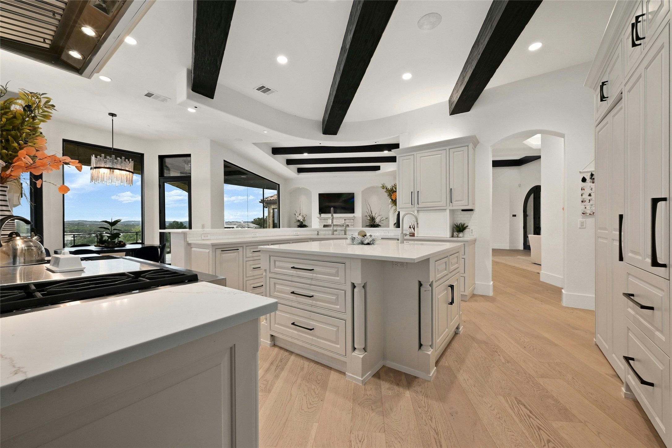 16012 Canard Circle Austin, TX 78734 - Photo 8 of 37 a kitchen with sink stove and white cabinets with wooden floor