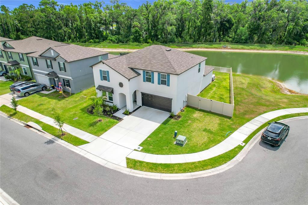 1633 Red Loop Lakeland, FL 33801 - Photo 58 of 60 a view of a house with a swimming pool and a yard