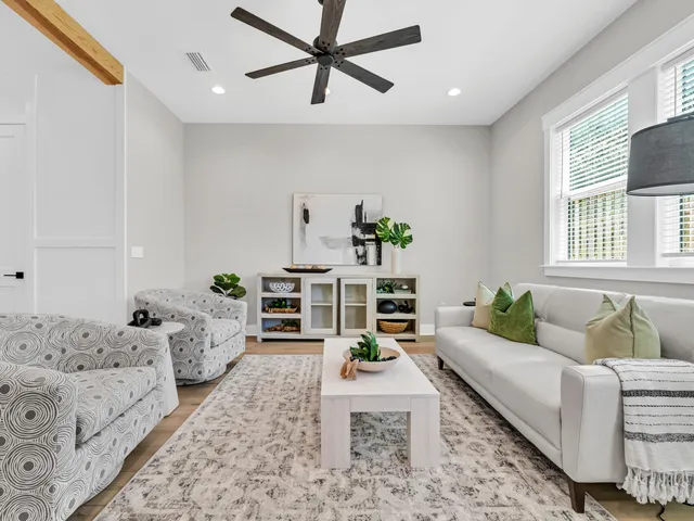 a living room with furniture and wooden floor