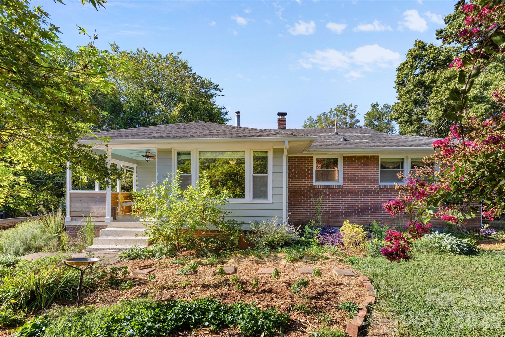 a front view of a house with a garden
