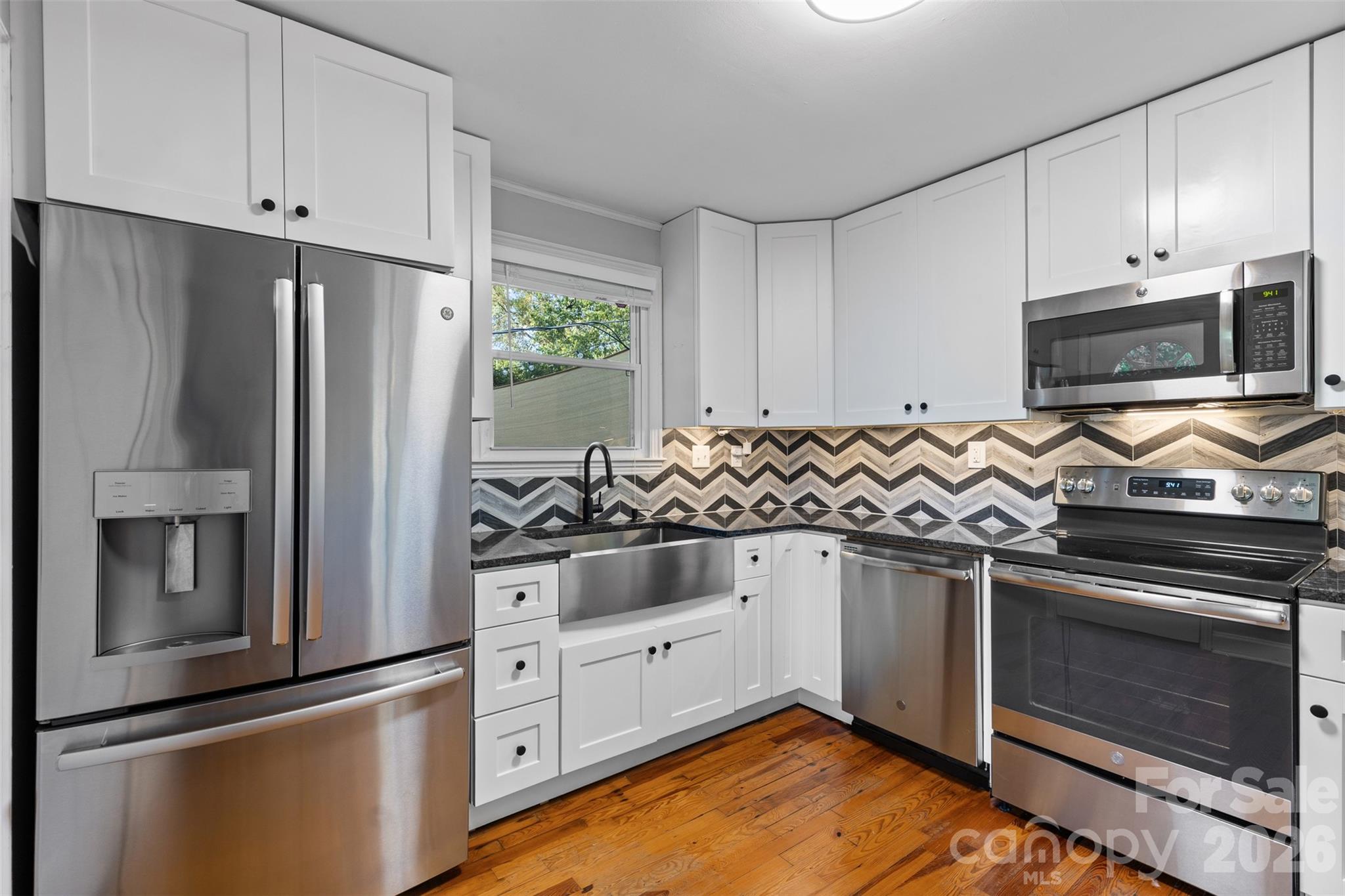 1638 Academy Street Charlotte, NC 28205 - Photo 7 of 30 a kitchen with granite countertop a stove and a refrigerator
