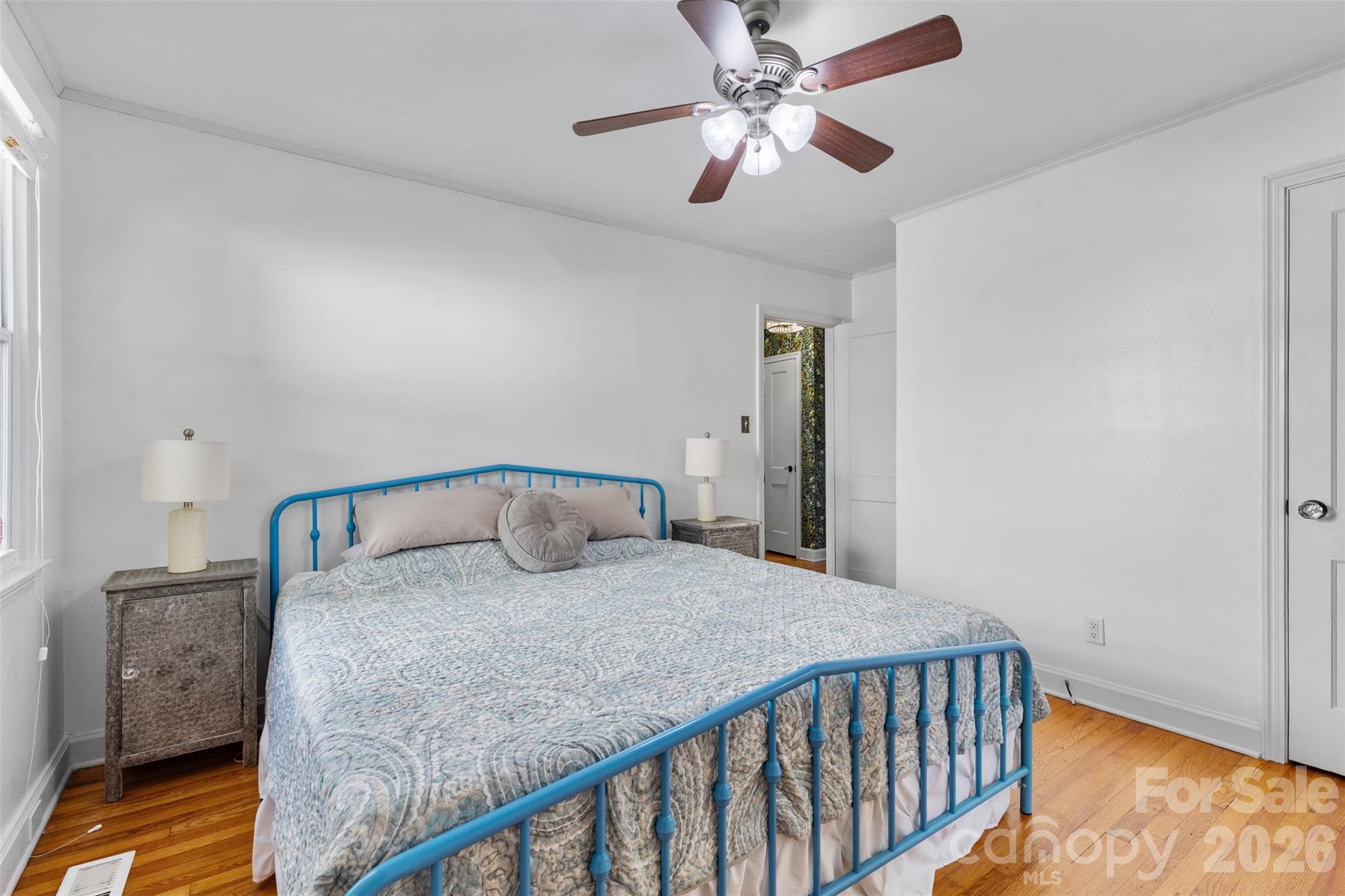 1638 Academy Street Charlotte, NC 28205 - Photo 9 of 30 a bedroom with a bed and a chandelier