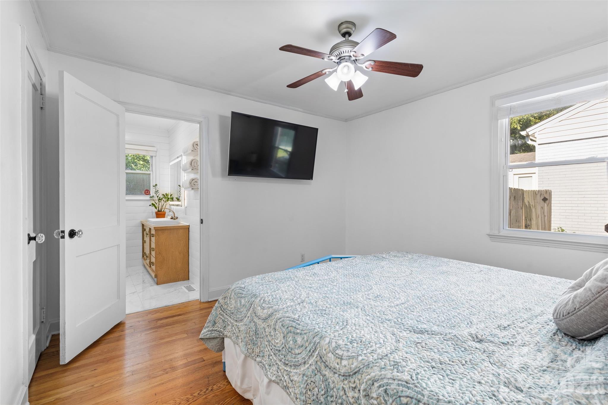 1638 Academy Street Charlotte, NC 28205 - Photo 10 of 30 a bedroom with a bed and a flat screen tv
