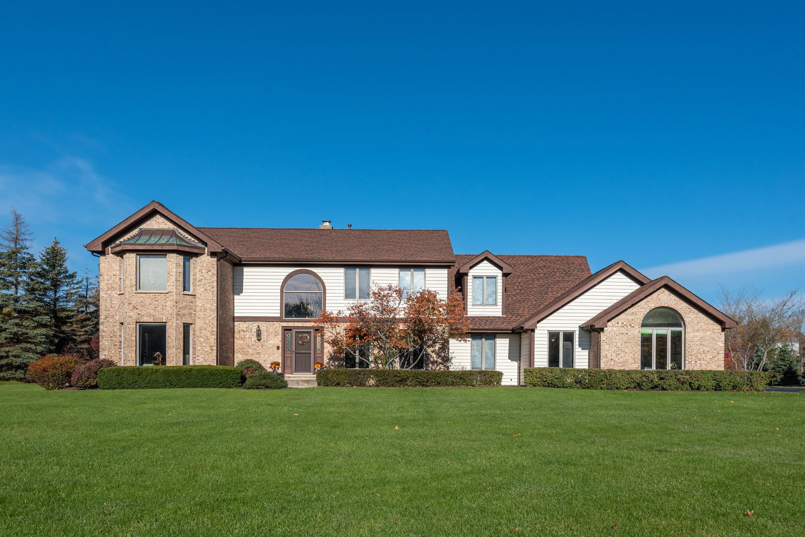 2208 Crystal Circle Crystal Lake, IL 60012 - Photo 1 of 55 a front view of a house with a yard