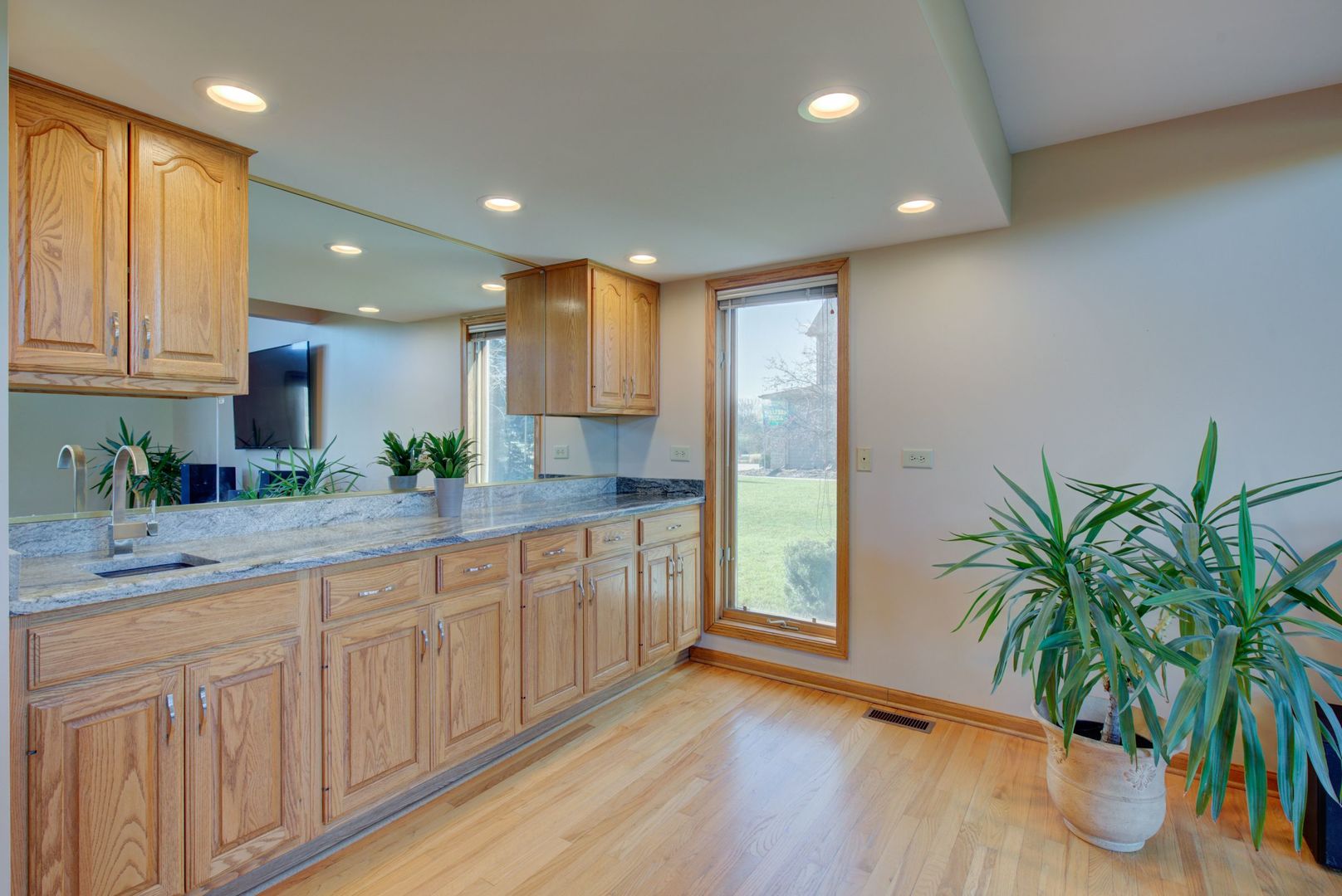2208 Crystal Circle Crystal Lake, IL 60012 - Photo 13 of 55 a kitchen with white cabinets and wooden floor