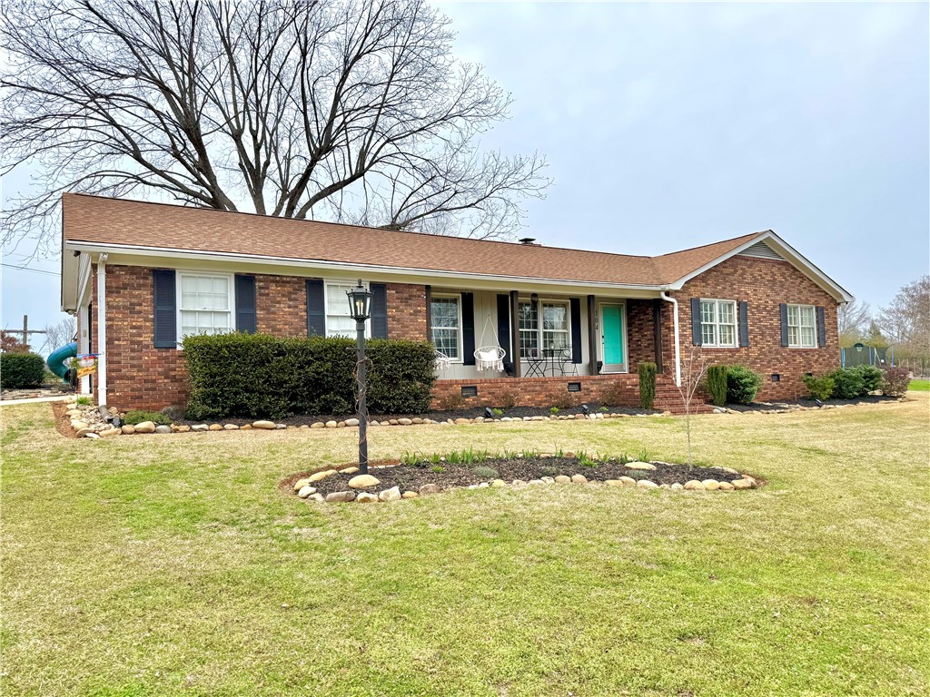 This classic brick residence features a well-maintained lawn and inviting front entrance.