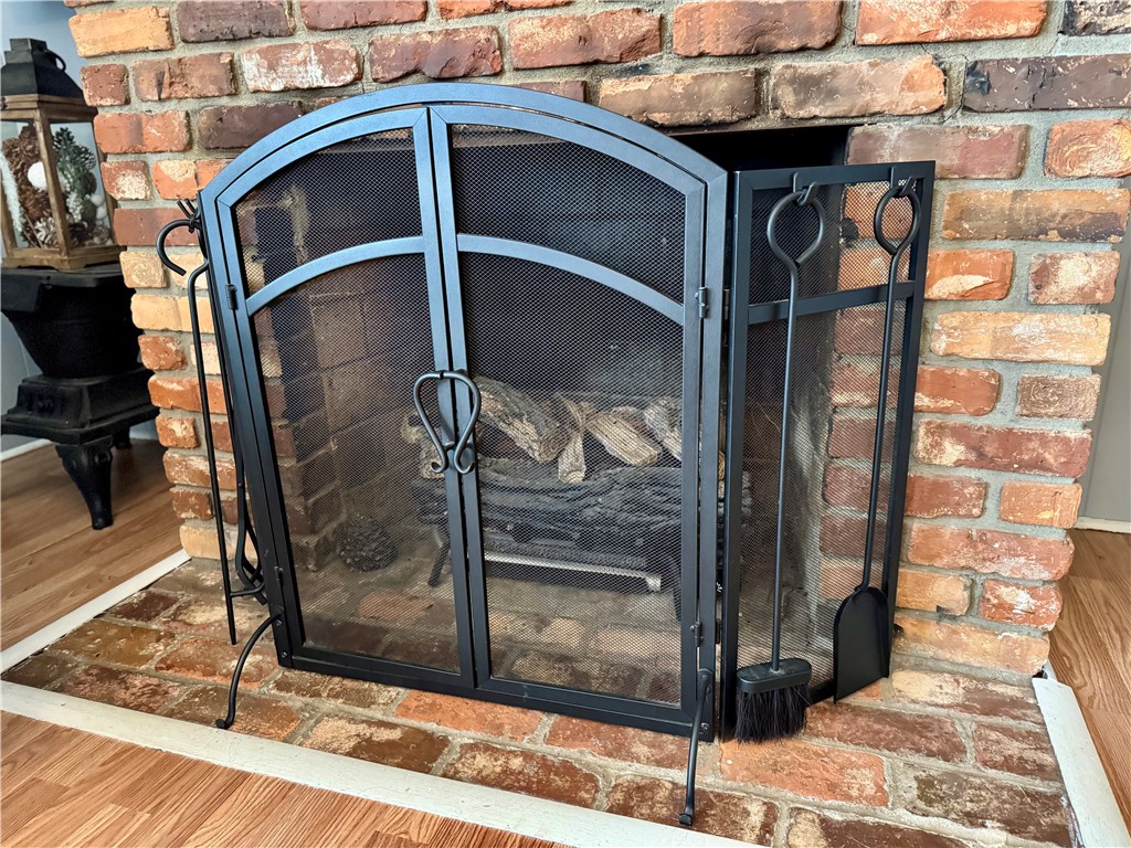 104 Lark Lane Anderson, SC 29625 - Photo 11 of 49 This cozy fireplace, crafted with classic brick, brings warmth and character to the living space.