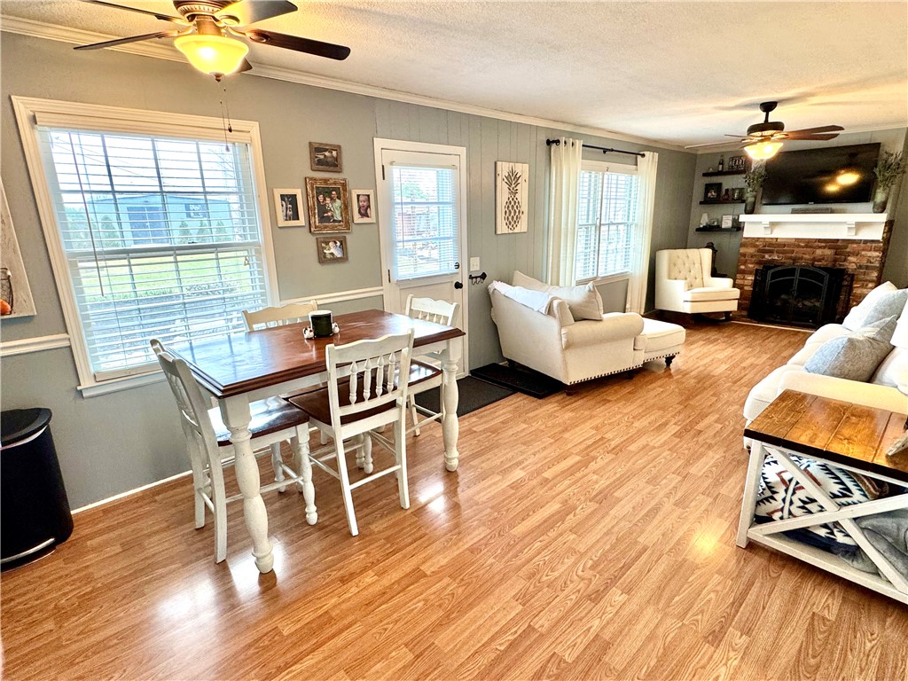 104 Lark Lane Anderson, SC 29625 - Photo 12 of 49 The den is open with the breakfast area and kitchen, and features abundant natural light, access to the patio and back yard, ceiling fans, and a cozy brick fireplace.