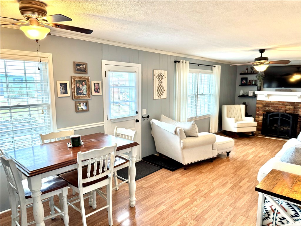 104 Lark Lane Anderson, SC 29625 - Photo 13 of 49 The den is open with the breakfast area and kitchen, and features abundant natural light, access to the patio and back yard, ceiling fans, and a brick fireplace.