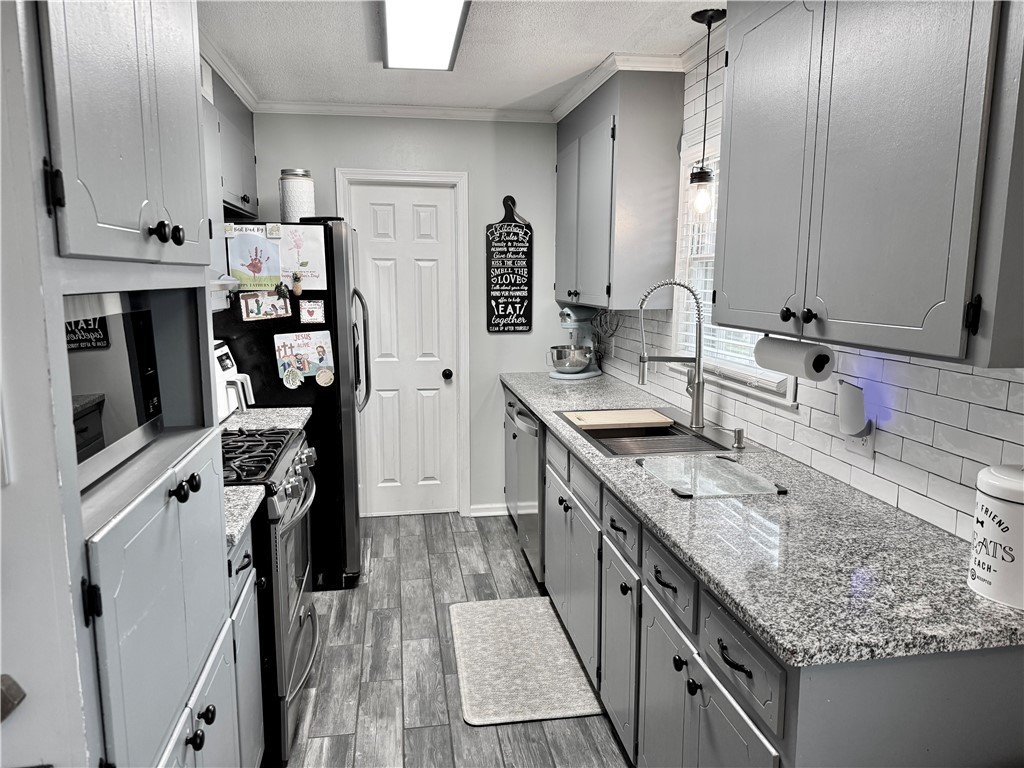 104 Lark Lane Anderson, SC 29625 - Photo 17 of 49 This kitchen features sleek countertops and modern appliances, creating a functional cooking space.