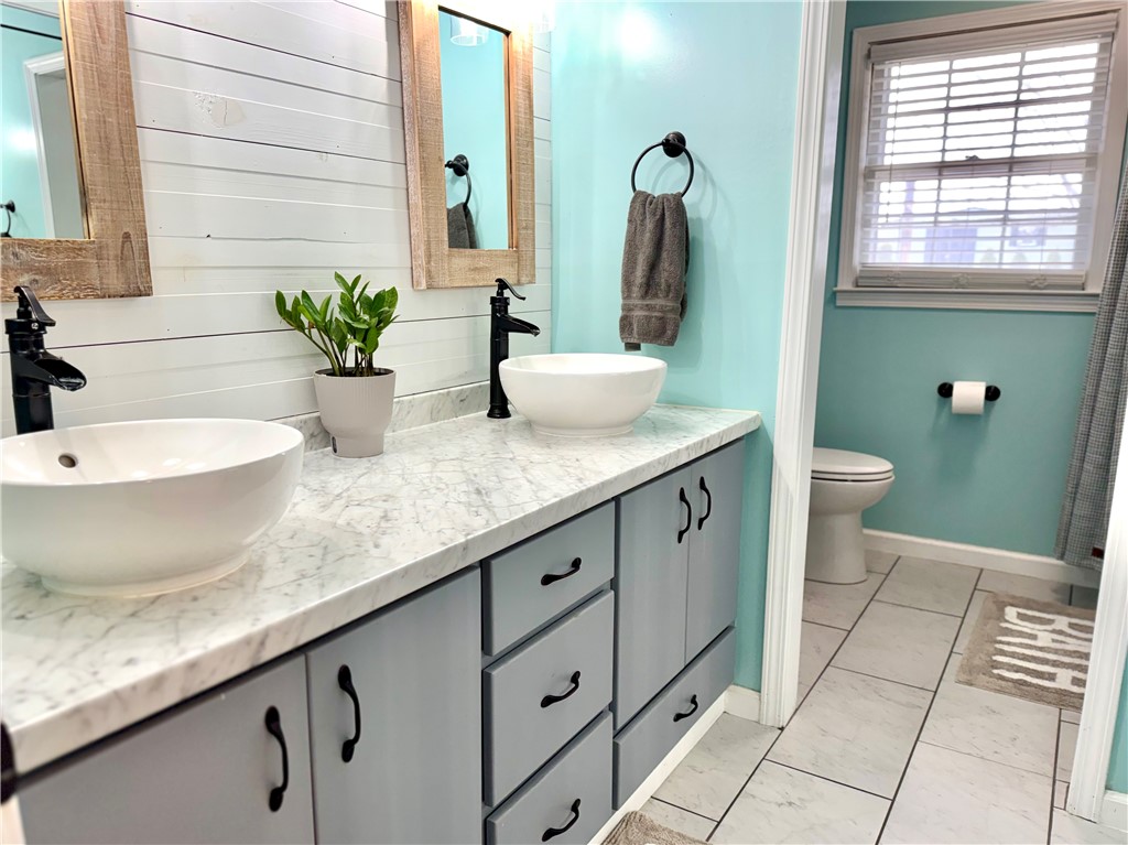 104 Lark Lane Anderson, SC 29625 - Photo 24 of 49 The hall bathroom features elegant countertops with dual bowl sinks and a clean, spacious design.