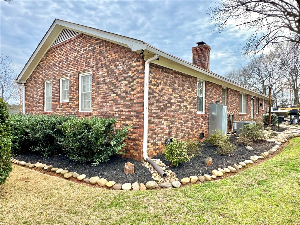 104 Lark Lane Anderson, SC 29625 - Photo 3 of 49 This charming brick exterior features well-maintained landscaping and a classic chimney.