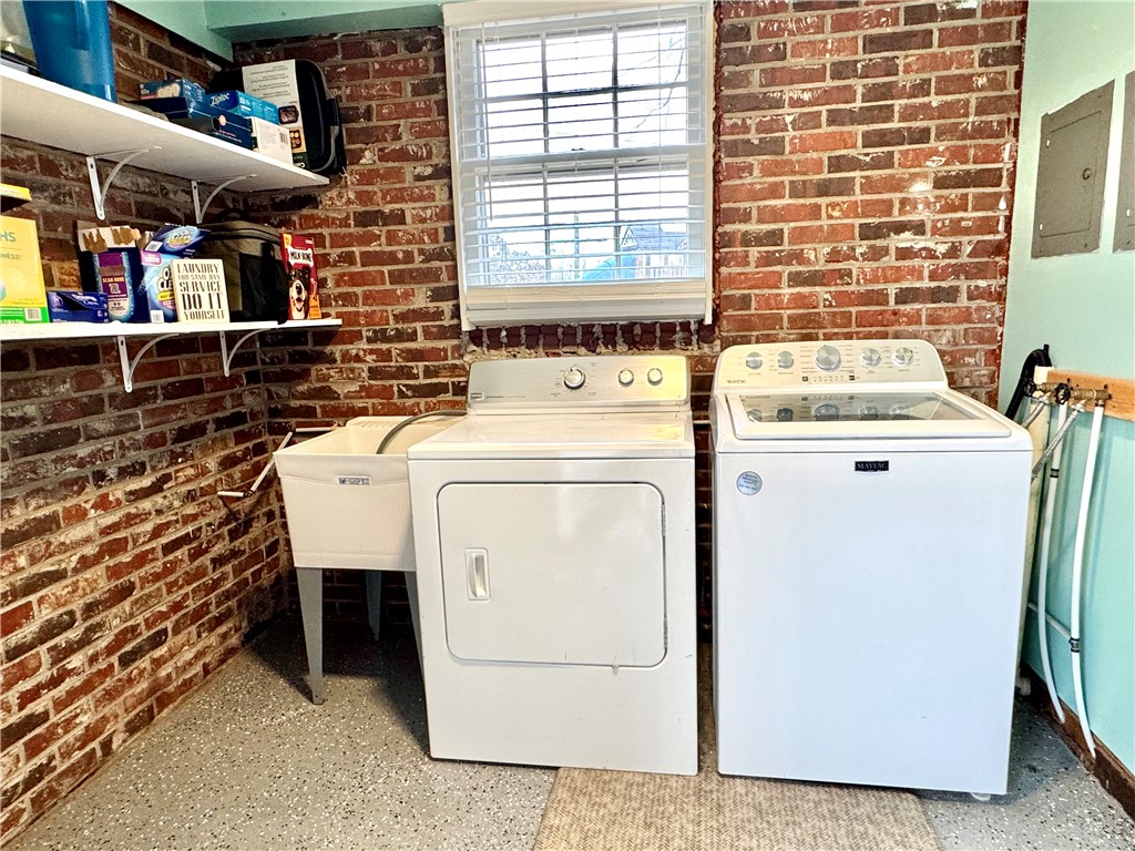 104 Lark Lane Anderson, SC 29625 - Photo 35 of 49 Functional laundry space with exposed brick accents and convenient shelving.