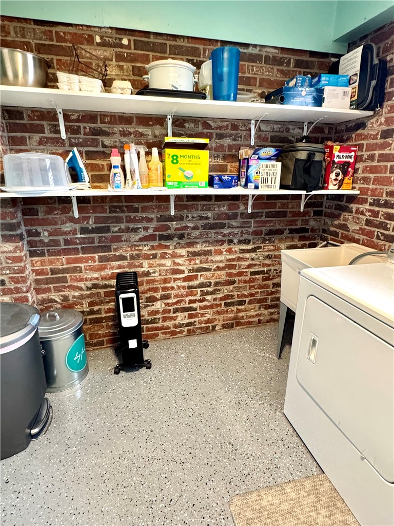 104 Lark Lane Anderson, SC 29625 - Photo 36 of 49 This laundry area features open shelving and durable flooring, perfect for daily chores.
