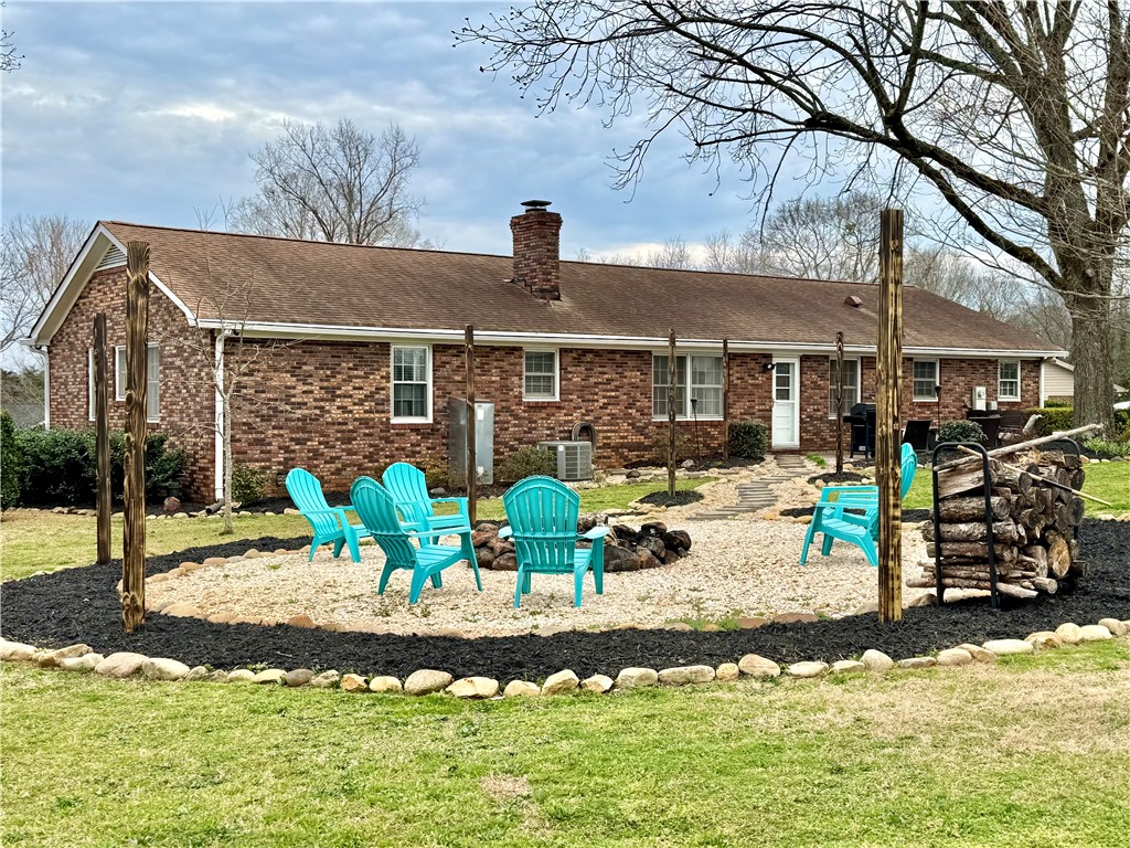 104 Lark Lane Anderson, SC 29625 - Photo 4 of 49 This inviting backyard offers a charming fire pit area, perfect for outdoor gatherings.