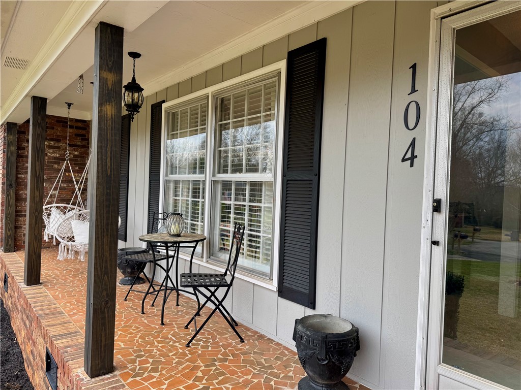 104 Lark Lane Anderson, SC 29625 - Photo 7 of 49 This charming brick residence features a welcoming front porch with clay ceramic tile flooring, perfect for enjoying peaceful outdoor moments.