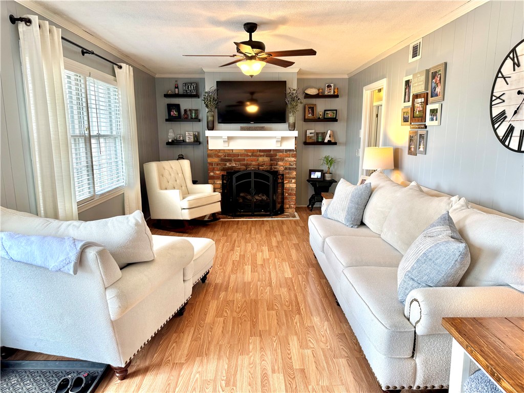 104 Lark Lane Anderson, SC 29625 - Photo 10 of 49 The den is open with the breakfast area and kitchen, and features abundant natural light, access to the patio and back yard, ceiling fans, and a cozy brick fireplace.
