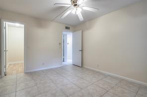 641 Normandy Lane, Unit N Delray Beach, FL 33484 - Photo 13 of 15 an empty room with a chandelier fan and closet area