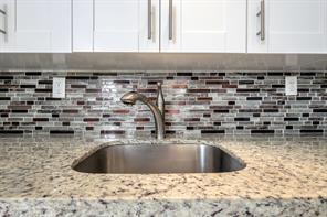 641 Normandy Lane, Unit N Delray Beach, FL 33484 - Photo 5 of 15 a kitchen with a sink and cabinets