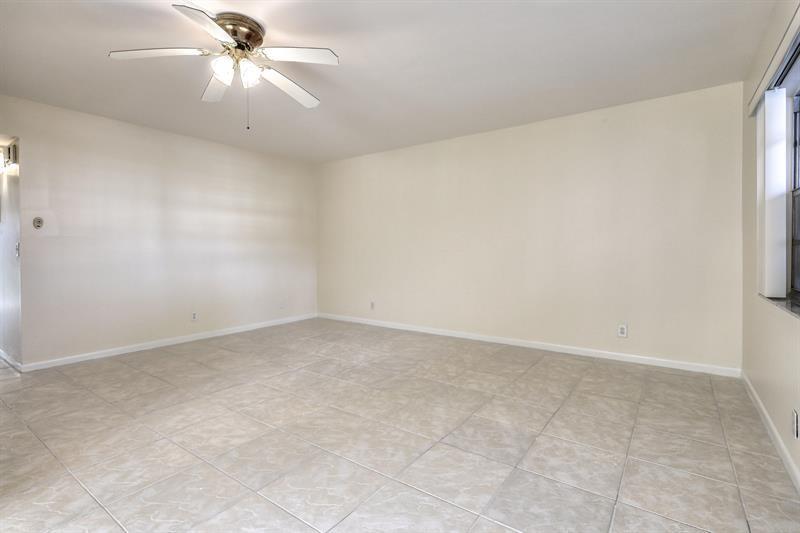 641 Normandy Lane, Unit N Delray Beach, FL 33484 - Photo 6 of 15 an empty room with a window and a fan
