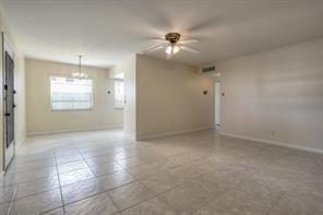 641 Normandy Lane, Unit N Delray Beach, FL 33484 - Photo 7 of 15 an empty room with windows and fan