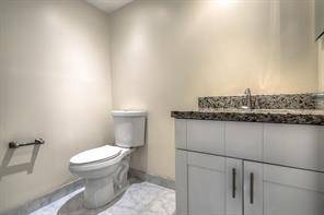 641 Normandy Lane, Unit N Delray Beach, FL 33484 - Photo 10 of 15 a bathroom with a granite countertop toilet and a sink