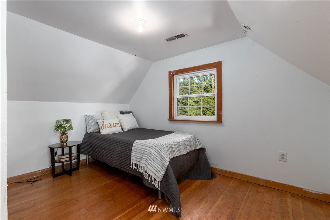 13909 Southwest Pohl Road Vashon, WA 98070 - Photo 13 of 24 a bedroom with a bed and a window