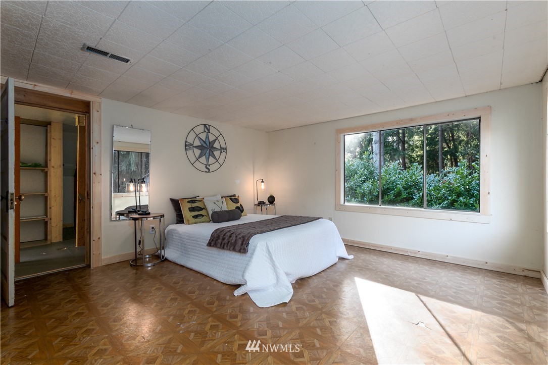 13909 Southwest Pohl Road Vashon, WA 98070 - Photo 16 of 24 a bed room with a bed and a large window