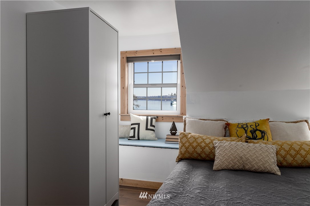 13909 Southwest Pohl Road Vashon, WA 98070 - Photo 17 of 24 a bedroom with a bed and a couch next to a window