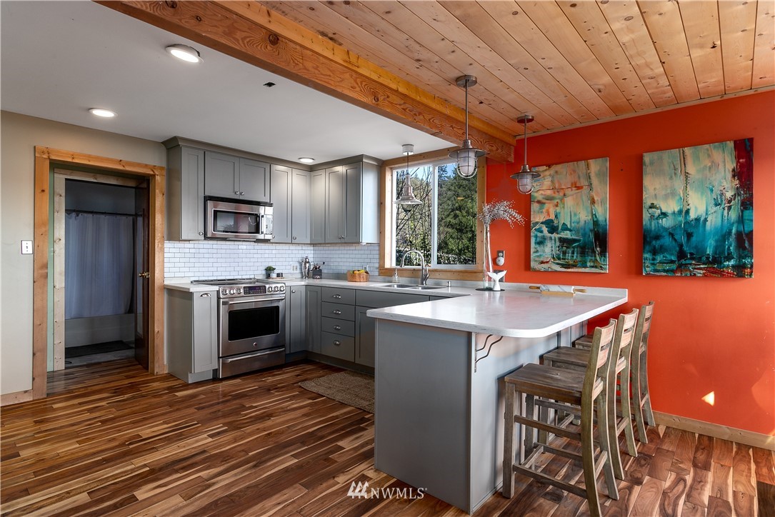13909 Southwest Pohl Road Vashon, WA 98070 - Photo 3 of 24 a kitchen with stainless steel appliances granite countertop a sink stove and refrigerator