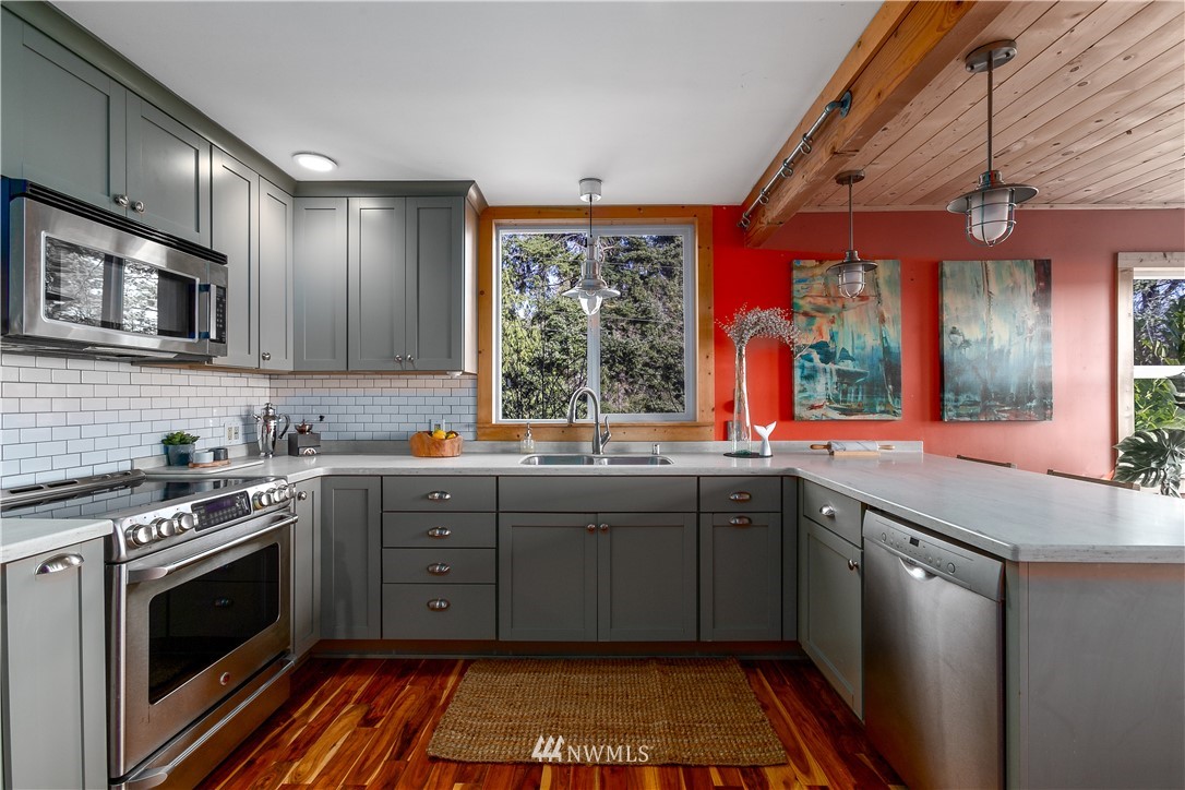 13909 Southwest Pohl Road Vashon, WA 98070 - Photo 4 of 24 a kitchen with stainless steel appliances a stove sink and microwave