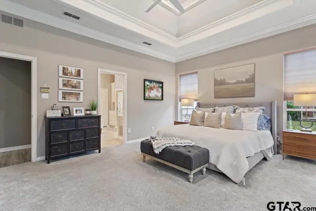 a bathroom with a tub a sink and a large mirror