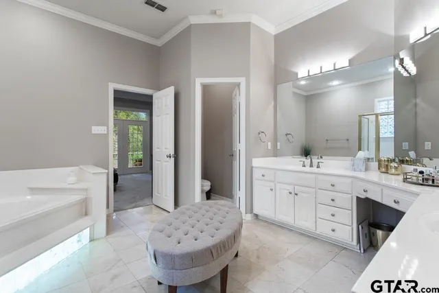 a large bathroom with a sink mirror toilet shower and bathtub