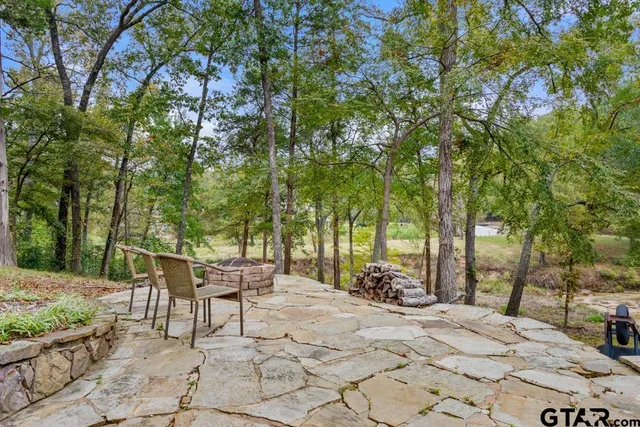 a view of a house with a yard and sitting area